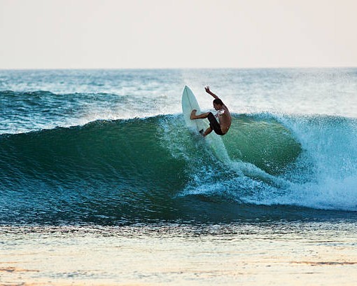 surfer hitting the lip